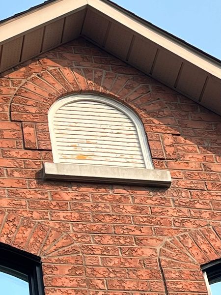 Before: Gable louvre window — peeling white frame and louvre repainted black