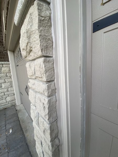 Garage door frame to stone column — perimeter bead