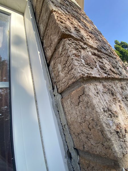 Removal, mid-job — the top bead cut out completely; the bottom bead is still the old caulking