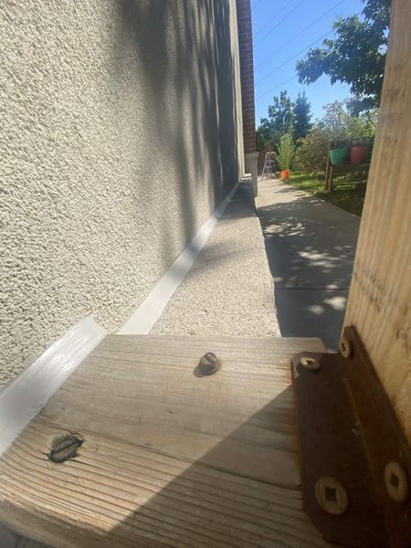 Stucco wall to walkway — joint sealed