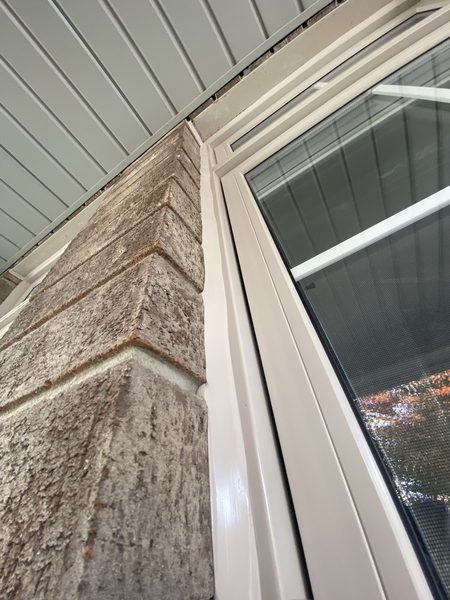 Window head to soffit corner — sealed and tooled