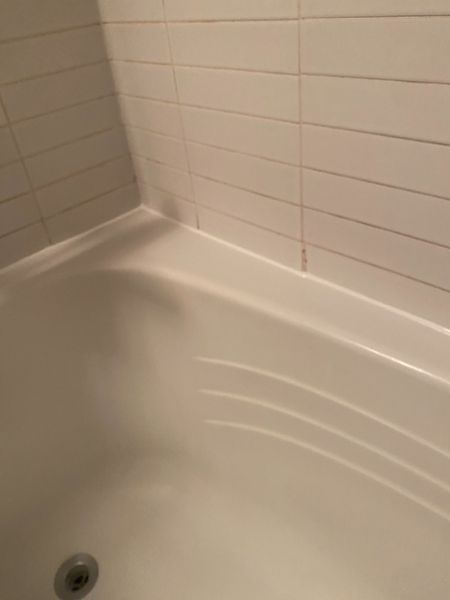 After: Shower corner: old silicone removed, clean tooled joint