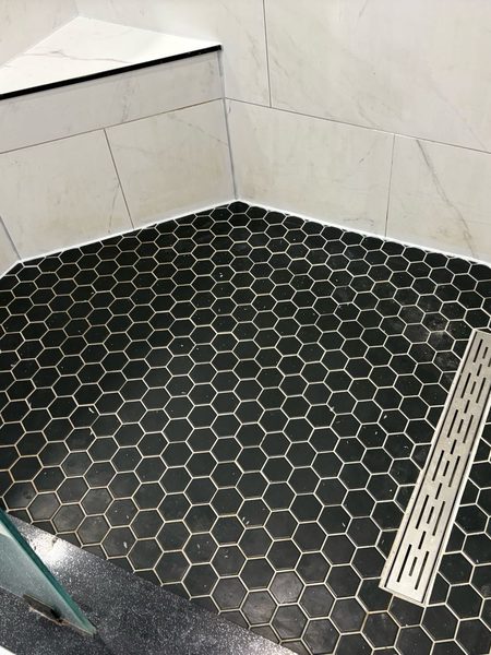 After: Shower floor and bench: the floor-to-wall silicone stripped, sanitized and resealed