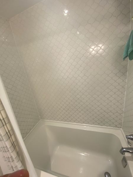 After: Tub surround corner: mould treated, joint rebuilt in sanitary silicone