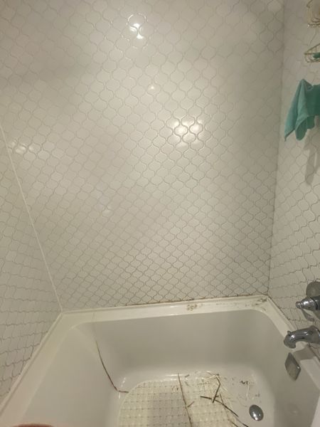 Before: Tub surround corner: mould treated, joint rebuilt in sanitary silicone