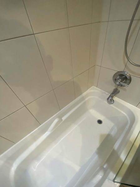 After: Tub-to-tile joint: the blackened bead stripped out and resealed