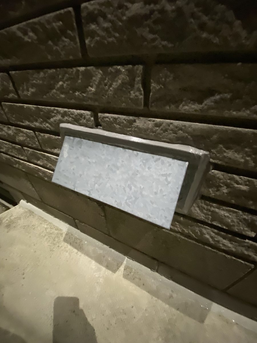 Louvre vent on stone — flange sealed, colour-matched