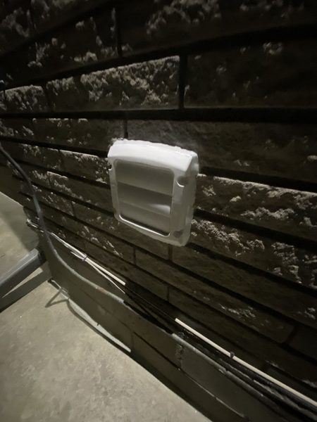 After: Open duct on stone — a new hood fitted and the flange sealed
