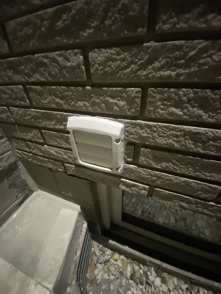 After: Exhaust hood on stone — the old hood out, new one sealed in
