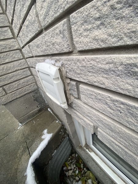 Before: Exhaust hood on stone — the old hood out, new one sealed in